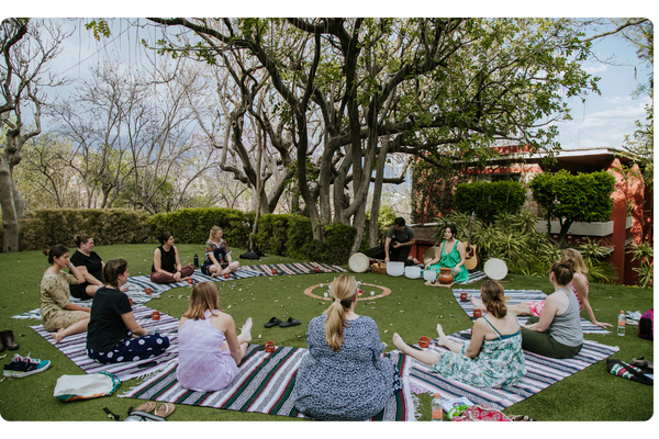 Women seated in a circle on the lawn at Casa Lyobaa